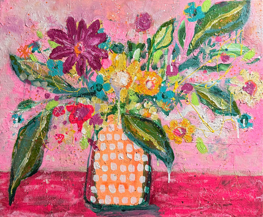 Colorful floral arrangement in a textured vase on a pink background